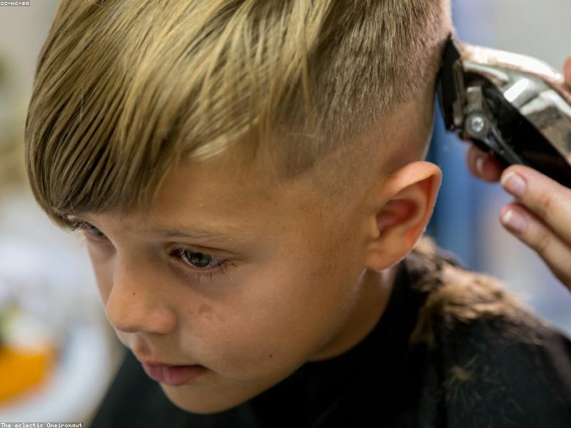Child getting a fresh fade with clippers